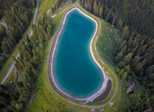 Aerial view of alpine mountain lake in Austria forest