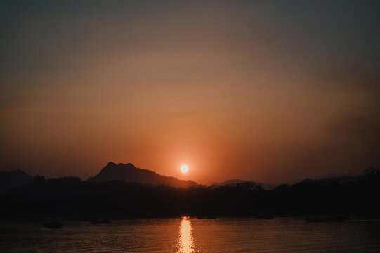 Sunset over the Mekong River in Laos mountain landscape