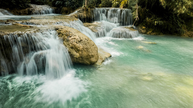 Kuang Si Waterfall cascades through forest in Laos
