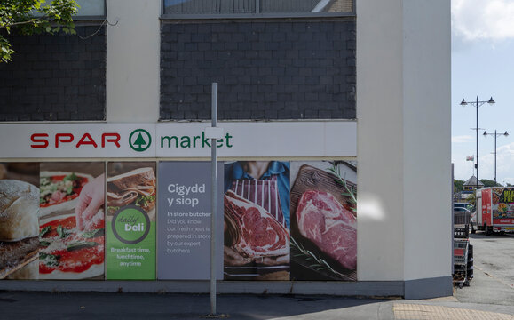 Pwllheli Gwynedd Wales 19th, July, 2026 Exterior View of SPAR Market Shopfront With Butcher Meat Posters and Deli Advertising