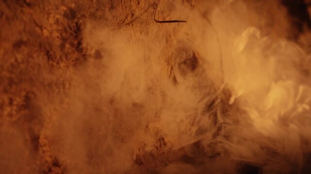 Mysterious white smoke billowing and rising from a hot, dry, and cracked surface. Intense atmospheric vapor and mist creating a dramatic and intriguing effect on a barren, desolate terrain