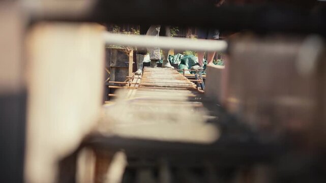 Construction workers preparing a building foundation, installing steel reinforcement bars and formwork before pouring concrete on a sunny day. Industrial building process for residential structure