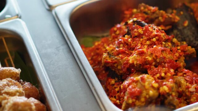 Golden crispy fried meatballs with shredded topping served and others delicious food served in metal tray lined with perfect for food events or restaurant vendors, elegantly showcasing tropical.
