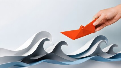 Hand holding an orange origami paper boat over layered paper waves representing rescue leadership and navigating through rough business seas