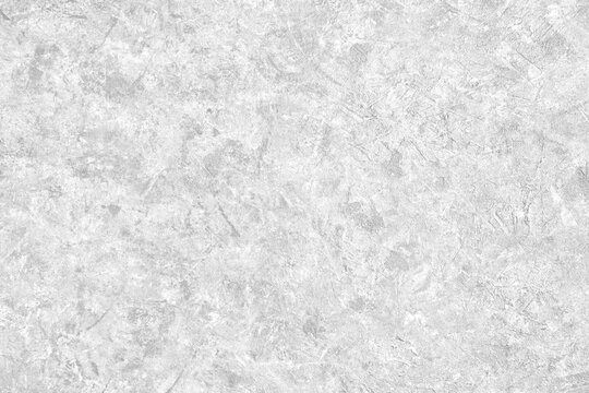 Abstract light grey plastered textured grunge background in the form of a rough covered stucco wall, closeup