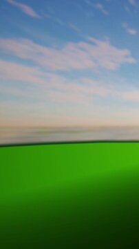 A clear sky spans overhead with light clouds. The ground displays a vibrant green color. This scene takes place during daylight in an open landscape without any people.