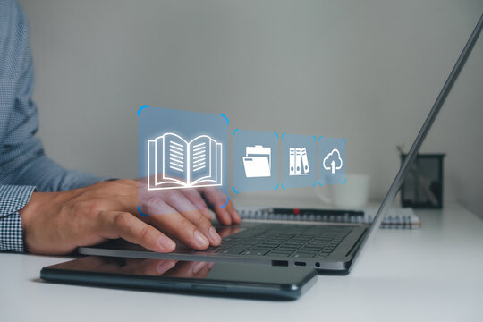 Businessman using a laptop and interacting with digital icons of books, folders and cloud storage, symbolizing document management, digital organization and cloud-based file storage.