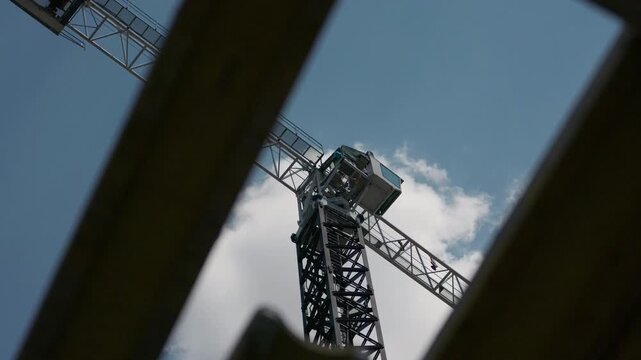 Tower crane operator cabin viewed through formwork panels close up