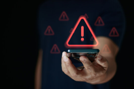 Cyber security warning concept with person holding smartphone, showing alert symbol and data risk notification. Cybersecurity, system error, data protection, hacking prevention, IT security services.