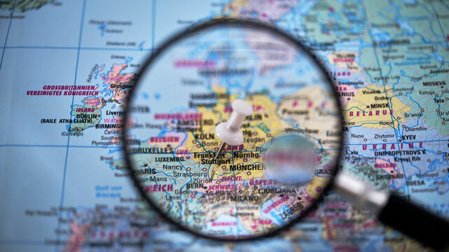 Magnifying glass focuses on a map of Stuttgart with highlighted locations
