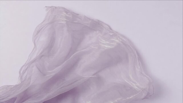 Cinematic macro fabric surface texture background pastel abstract wave gentle motion dreamy flow soft highlight delicate wrinkle cloth folds air light minimal art flowing lavender cloth wave romantic