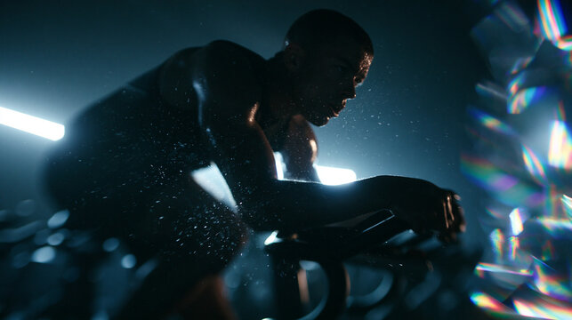 Athletic Man Riding Stationary Bike During Intense Workout
