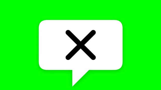 White speech bubble with black cross on green background.