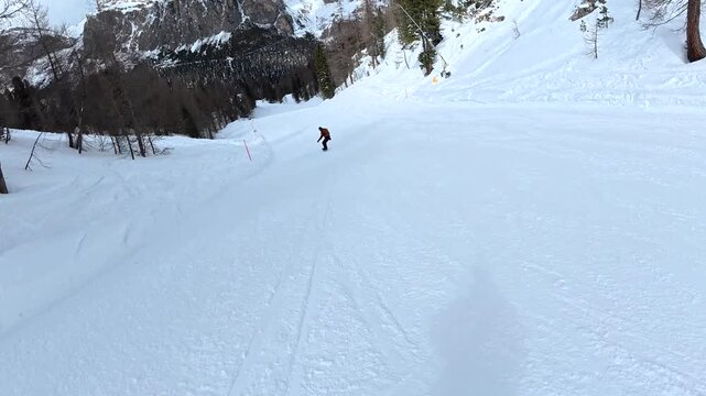 Point of view snowboarding downhill in the dolomites