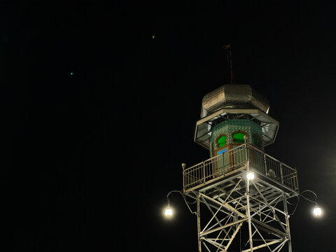 The Great Mosque of Demak Tower is a historic building located in the Great Mosque complex of Demak, Central Java. Illuminated mosque minaret tower with dome at night against dark sky