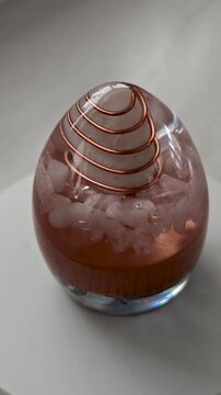 Rotating Golden Orgonite Egg with Quartz Crystal, Handmade Epoxy Resin Energy Sculpture, Vertical 360 Degree Crystal Art Video, Luxury Spiritual Decor on White Background