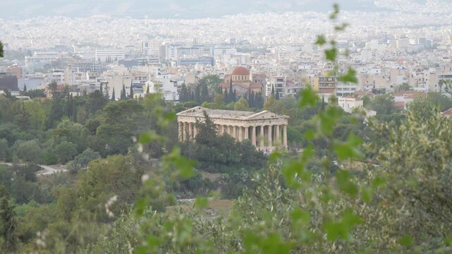 Majestic view of the Temple of Hephaestus sitting above the sprawling cityscape of Athens