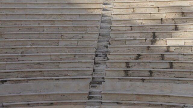 Detailed view of the empty ancient marble seats of the Odeon of Herodes Atticus in Athens, Greece