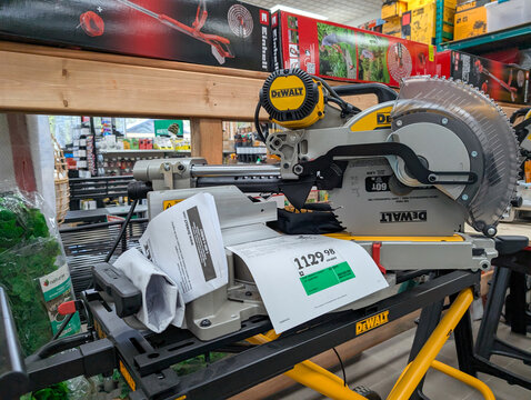 Quebec, Canada, 22 April 2026 : A DEWALT miter saw with a price tag and instruction manual sits on display in a retail store.