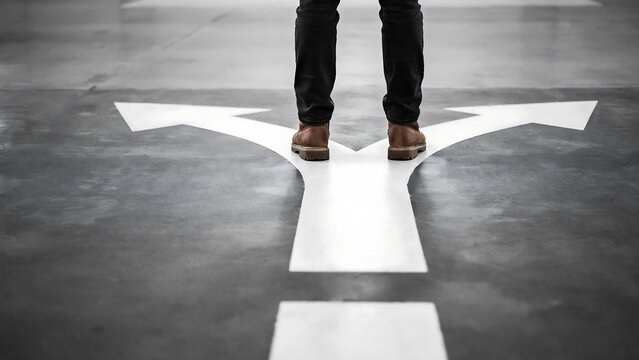 Person standing at a divided path road direction choice with decision direction business strategy planning lifestyle opportunity thinking uncertainty motivation standing