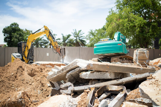 Close up of broken concrete slabs and rubble piled at demolition site