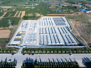 Aerial view of a large-scale energy storage power station with battery arrays and industrial...