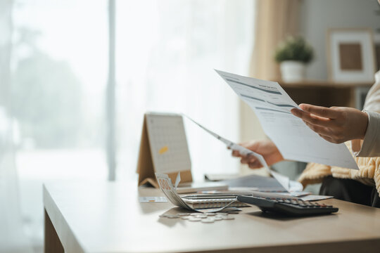 bill review, financial paperwork, and calculator shape this practical household finance scene. It conveys practical choices, organized planning, everyday money management, and financial awareness.