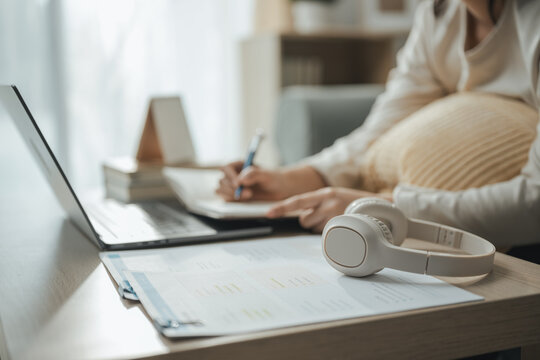 financial research, laptop, and writing notes shape this practical household finance scene. It conveys practical choices, organized planning, everyday money management, and financial awareness.