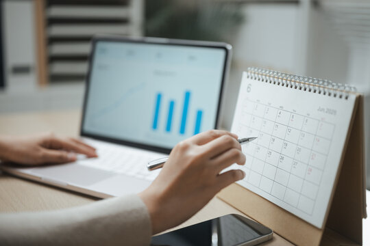 financial schedule, calendar, and financial chart shape this practical household finance scene. It conveys practical choices, organized planning, everyday money management, and financial awareness.