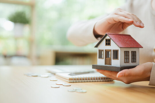 home insurance, property protection, and house model shape this practical household finance scene. The setting supports organized records, careful decisions, responsible spending, and clear planning.