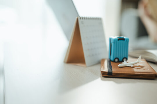 This focused image brings together vacation planning, travel schedule, and miniature suitcase. It conveys practical choices, organized planning, everyday money management, and financial awareness.