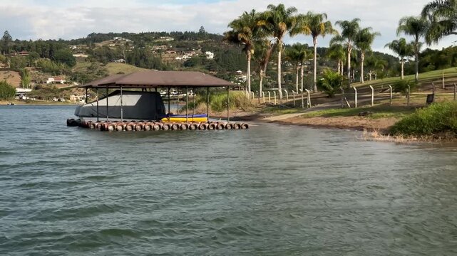 4K 60fps POV Boat Passing Dock with Kayaks Lake Calima Colombia