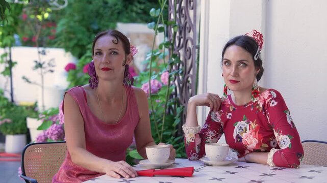 Elegant Flamenco Women Enjoying Coffee in Traditional Spanish Village Cafe