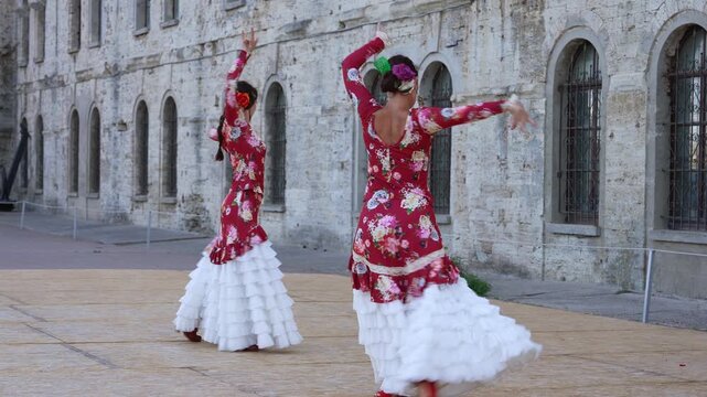 Authentic Flamenco Dancers Performing in Red Dresses on Historic Street