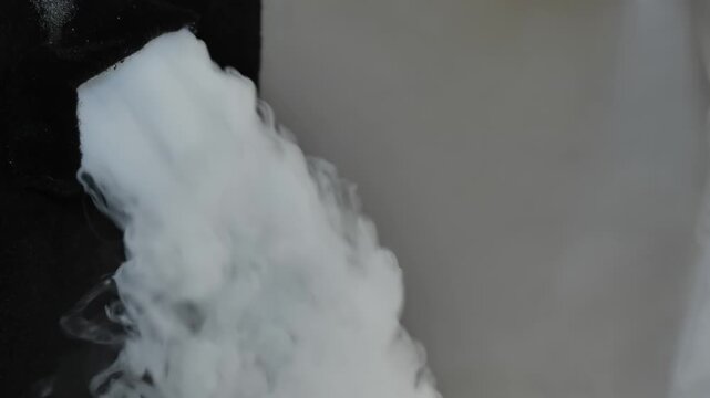 Fog machine emitting heavy smoke creating special effects at a party