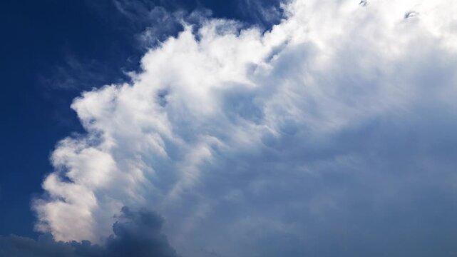 White clouds time lapse. Clouds running across the blue sky. 4k Timelapse of white clouds with blue sky background. Weather concept b roll shot.