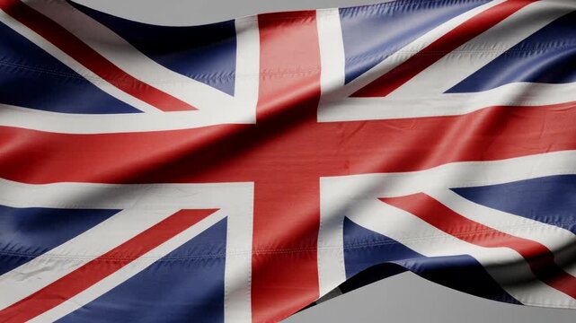 Waving Union Jack flag of the United Kingdom with vibrant red white and blue colors in motion