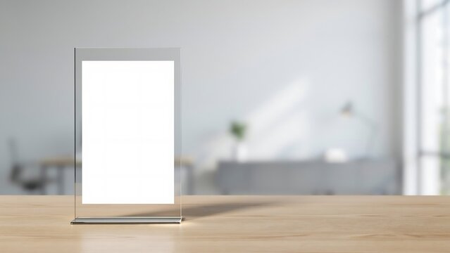 Empty acrylic sign holder on a wooden table in a modern office