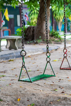 Educational Parenting. Empty Metal Chain Swing in Playground