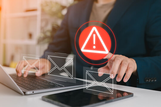 Businessman using laptop with electronic email hacking and spam warning symbol. cyber attack network, virus, spyware, Cyber security and cybercrime.