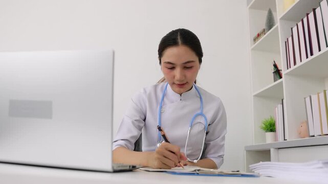 Young female doctor providing online medical consultation via video call.