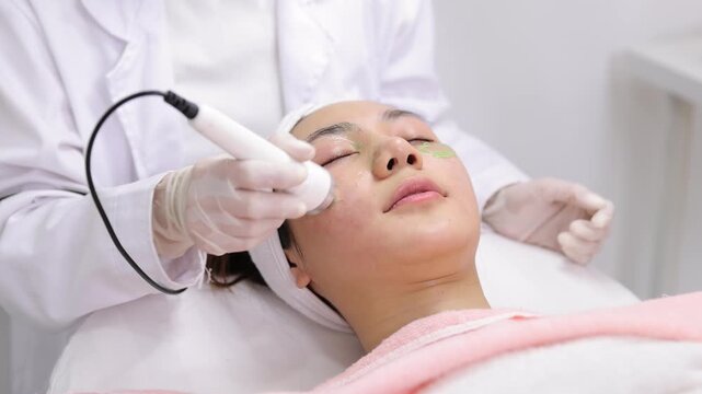 Asian woman receiving facial skincare rejuvenation treatment.