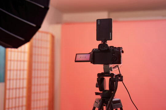 Digital camera on tripod set up in photo studio for video production