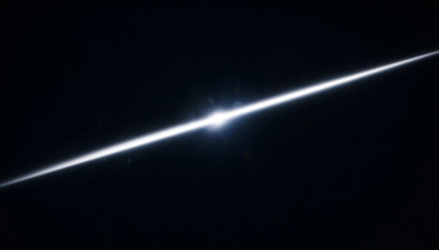 A bright diagonal beam of white light creating a sharp glowing light effect on a dark black background