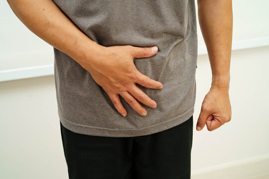 Hernia, Asian man stomach ache, abdominal pain and urology problem health.