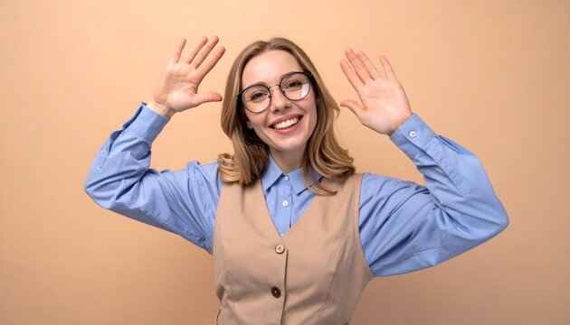 Happy young woman wearing glasses and vest celebrating with hands up