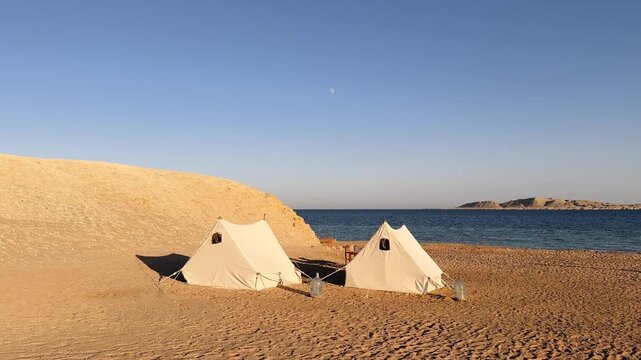 Desert Camping Tents on Sandy Beach of Red Sea and Island in Background in Ras Muhammad National Park