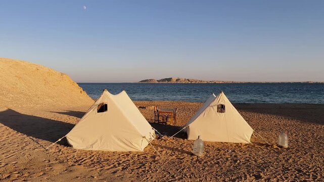 Bedouin Desert Camp with two White Tents on Sandy Beach with Red Sea View in Ras Muhammad National Park at sunset
