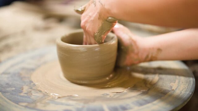 Artisan Hands Shaping Clay Pot on Spinning Pottery Wheel