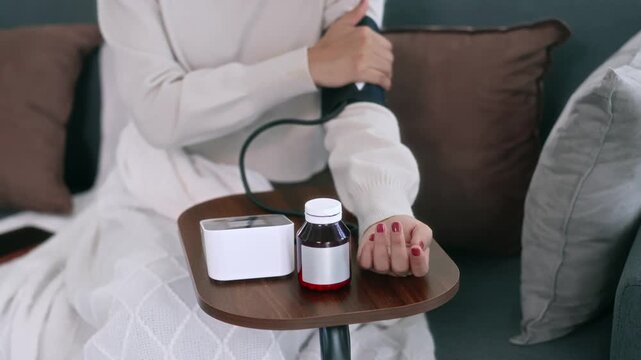 Female  monitoring blood pressure at home